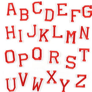May include: Red felt letter patches in uppercase, A through Z, with white outlines. The letters are arranged in three rows.