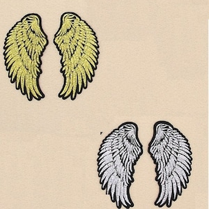 May include: Two pairs of iron-on patches in the shape of angel wings. One pair is gold and the other is silver.