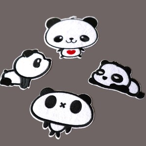 May include: Four embroidered panda bear patches in various poses. Each patch features a white body, black ears, eyes, and markings. One panda has a red heart. The patches are outlined in black.