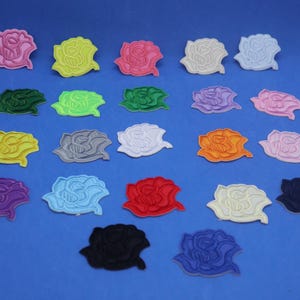 May include: Assortment of 20 iron-on embroidered rose patches in various colors, including pink, yellow, green, gray, white, orange, purple, red, blue, and black.