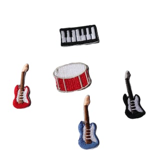 May include: Five embroidered iron-on patches featuring musical instruments: a red electric guitar, a blue electric guitar, a black electric guitar, a red drum, and a black and white keyboard.