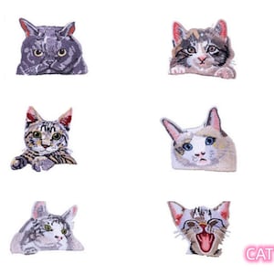 May include: Six embroidered iron-on patches featuring different cat designs. The patches are all in various shades of grey, brown, and white. The cats are all in different poses, some are looking at the camera, some are looking away, and some are yawning. The patches are all about 2 inches in size.