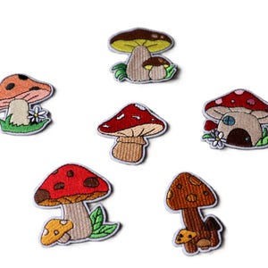 May include: Six embroidered mushroom patches in various colours and designs. The patches feature red, orange, brown, and yellow mushroom caps with detailed stitching. Some patches include small flowers and green leaves.