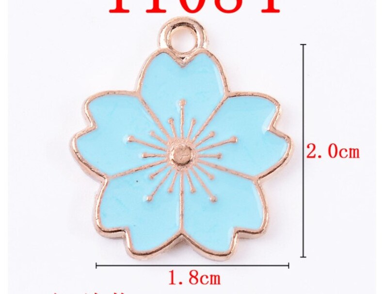 May include: A light blue enamel flower charm with a gold-tone finish. The charm is 1.8 inches wide and 2 inches tall.