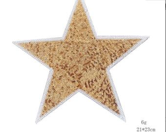 May include: Gold star-shaped sequin patch with a white outline. The patch is 21 inches by 23 inches and has glue on the back.