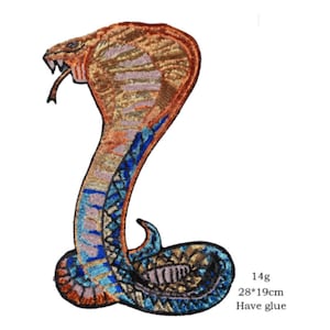 May include: Embroidered cobra patch in shades of brown, orange, and blue. The patch measures approximately 28cm by 19cm and features intricate detailing. The patch has the text "Have glue".