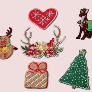 May include: A collection of embroidered Christmas patches. Designs include a reindeer, a red heart with snowflakes, floral antlers, a gift, a Christmas tree, and a reindeer with a green blanket.