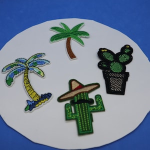 May include: Five embroidered iron-on patches featuring a green cactus wearing a sombrero, a green cactus, a green potted cactus, and two palm trees.