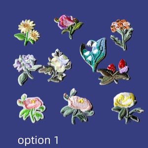 May include: A collection of ten embroidered flower patches featuring various botanical designs in colours including yellow, pink, purple, orange, white, and green. The text "option 1" is printed in white at the bottom of the image.
