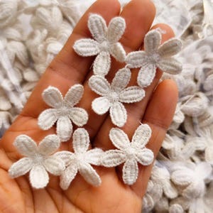 May include: A set of three ceramic mugs with a speckled, matte finish in cream, light brown, and dark brown. Each mug has a simple design and a rounded handle.