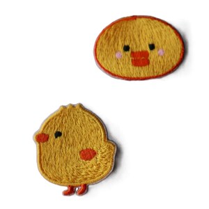 May include: Two yellow embroidered iron-on patches, one of a chick and one of a chick's face. Both patches have orange accents.