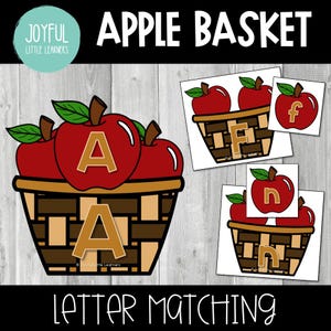 Peut inclure: Illustration numérique d'un panier de pommes avec le texte "APPLE BASKET" au-dessus. Le panier contient des pommes rouges avec la lettre "A". De petites cartes montrent des pommes avec les lettres "f" et "n". Le texte "LETTER MATCHING" est en dessous.