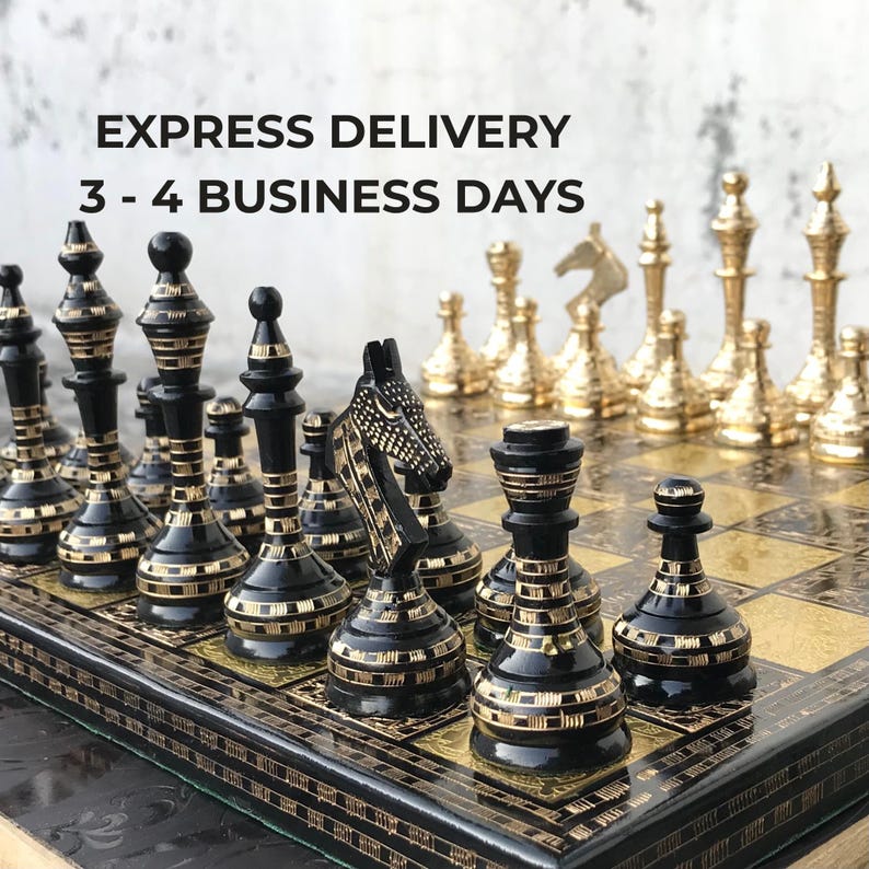 May include: A chess set featuring black pieces with gold-coloured etched horizontal lines and metallic gold-coloured pieces. The board has a black and gold-coloured grid pattern. Text on the image reads: EXPRESS DELIVERY 3 - 4 BUSINESS DAYS.