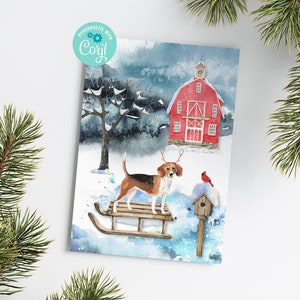 May include: A watercolor illustration of a beagle dog wearing a reindeer antler headband, standing on a wooden sled in a snowy winter scene. A red cardinal bird is perched on a birdhouse in the background, and a red barn with a white cross on top is visible in the distance.