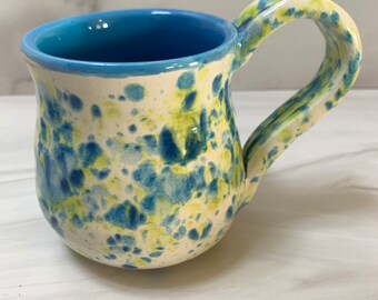 Turquoise, green and white pottery coffee cup in the colors of Van Gogh Iris painting