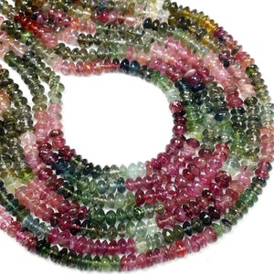 May include: A strand of multi-colored tourmaline beads. The beads are faceted and have a smooth, polished finish. The colors of the beads include pink, green, and blue.