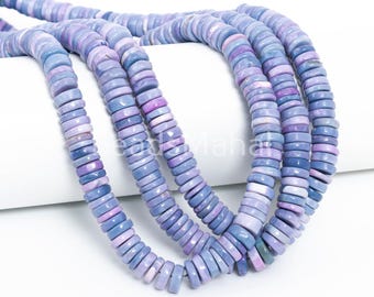 May include: Strands of light purple and blue gemstone beads. The beads are flat, disc-shaped, and strung together. The color gradient ranges from pale lavender to deep periwinkle. The beads are arranged in a cascading pattern against a white background.