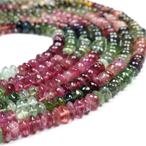 May include: A strand of multi-colored gemstone beads. The beads are faceted and have a teardrop shape. The colors of the beads are pink, green, and blue.