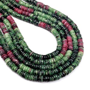 May include: Strands of gemstone beads in shades of green, dark green, and red. The beads are small, flat, and round, strung together to form necklaces. The beads have a natural, polished appearance, with variations in color and texture.