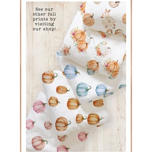 May include: White fabric with watercolor pumpkin patterns in orange, pink, and blue. Some pumpkins are adorned with floral arrangements. The text "See our other fall prints by visiting our shop!" is visible.