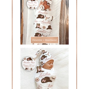 May include: Two images of a baby swaddled in a white swaddle with a pink and brown cowboy hat and boot pattern. The first image shows the baby wearing a pink headband with a bow. The second image shows the baby wearing a pink and brown cowboy hat. Both images include a round, white tag with the text "Amelia Mae" and spaces for the baby's birth information.
