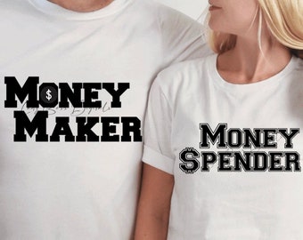 May include: White t-shirts with black text. One shirt says "Money Maker" with a dollar sign graphic, and the other says "Money Spender" with a dollar sign graphic. The shirts are likely for couples or friends.