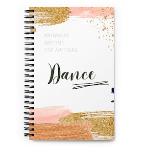 May include: Spiral-bound notebook with a white cover featuring the word "Dance" in a dark green script. The cover also includes the text "ANYWHERE ANYTIME FOR ANYTHING:" and abstract gold, pink, and bronze brushstrokes.