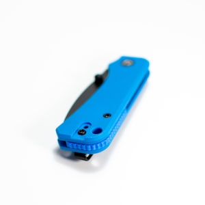 May include: A blue pocket knife with a black blade and a textured handle. The knife has a pocket clip and a small hole for a lanyard.