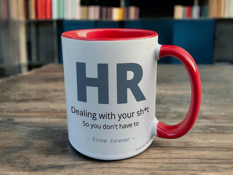 Red & White Ceramic Mug with HR Design sat on a table. The Cup has a standard handle.