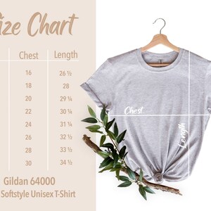 Pu&ograve; includere: Una maglietta unisex Gildan 64000 grigio chiaro &egrave; appesa a una gruccia di legno. Una tabella delle taglie mostra le misure del petto e della lunghezza in cm per le taglie XS-4XL. Il verde fa da contorno alla maglietta.