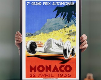 May include: A vintage poster advertising the 7th Grand Prix Automobile in Monaco on April 22, 1935. The poster features a white race car speeding down a road with a view of the city of Monaco in the background. The poster is in red, blue, yellow, and black.
