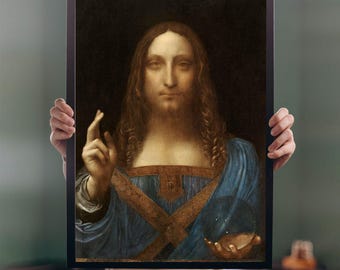May include: A framed print of the Salvator Mundi painting. The artwork depicts a figure with long, wavy brown hair and a beard, wearing a blue robe with gold accents. The figure holds a crystal orb in one hand and raises the other hand in a blessing gesture.