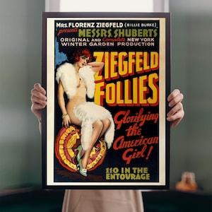May include: A framed vintage poster for the Ziegfeld Follies, featuring a woman in a fur stole. The poster has text that reads "Glorifying the American Girl!" and "110 in the Entourage."