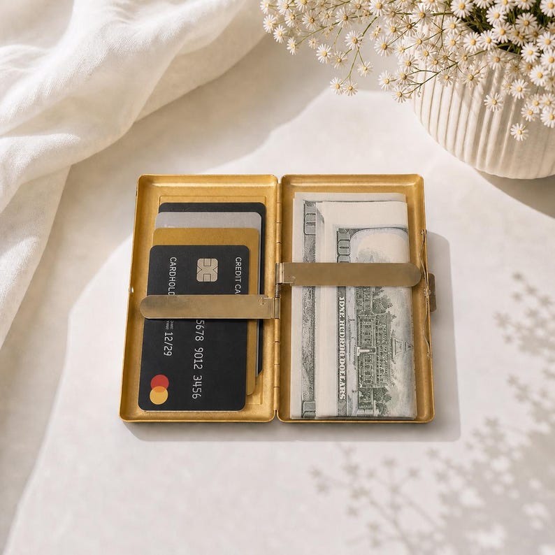 Gold cigarette case used as card holder with cash and credit cards