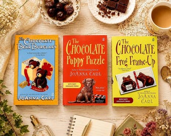 3 pc Lot Vintage CHOCOLATE Mystery Paperback Books by Joanna Carl: Chocolate Bear Burglary; Puppy Puzzle; Frog Frame-Up. Cozy Mystery Series