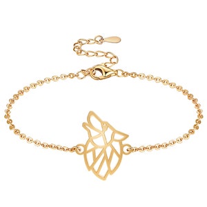 May include: Gold-colored bracelet featuring a howling wolf pendant. The adjustable chain bracelet has a lobster clasp closure and a small charm at the end. The wolf pendant is a geometric design.