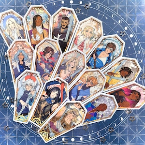 May include: A selection of coffin-shaped stickers with character illustrations. Each sticker has a gold border and a stained-glass style design. The characters are shown with swords, chains, and other accessories, in various colours.