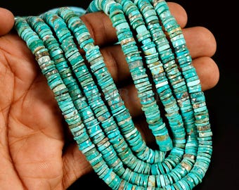 May include: Strands of turquoise gemstone beads. The beads are flat, disc-shaped, and a vibrant turquoise color with natural variations. The beads are strung together, creating a layered effect. The image is a close-up, showcasing the texture and color of the gemstones.