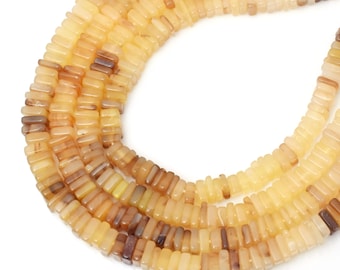 May include: Strands of rectangular beads in shades of yellow, tan, and brown. The beads are strung together, forming a necklace or bracelet. The beads have a polished, glossy finish and are arranged in a curved pattern against a white background.