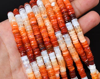 May include: Multiple strands of small, flat, disc-shaped beads in varying shades of orange, red, and white. The beads have a smooth, semi-translucent finish and are arranged in parallel rows, showcasing a gradient of warm, vibrant colors.