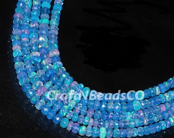 May include: Strands of faceted, light blue opal beads. The beads have a subtle iridescence with hints of pink and green. The image includes the text "CraftNBeadsCO". These beads are suitable for jewelry making.