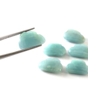 Pode incluir: Seis pedras de aquamarina azul claro em forma de coração. As pedras são lisas e polidas.