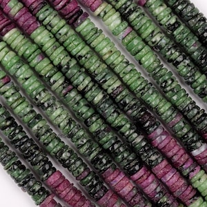 May include: Close-up of strands of gemstone beads. The beads are flat, disc-shaped, and feature a mix of colors including deep red, green, and black. The beads are strung together, creating a textured and colorful pattern. Ideal for jewelry making.