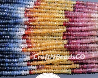 May include: Strands of colorful gemstone beads in shades of blue, white, yellow, orange, and pink. The beads are small and faceted, with a polished appearance. The image includes the text "CraftNBeadsCo".