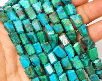 May include: A strand of faceted, irregular, nugget-shaped beads in vibrant shades of turquoise, teal, and deep forest green. Each bead features unique natural veining and color variations, strung together to form a continuous, textured jewelry component.