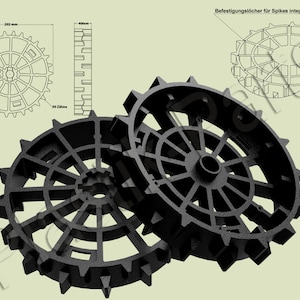 Puede incluir: Dos ruedas de metal negro con un diseño circular y radios. Las ruedas tienen un diámetro de aproximadamente 202 mm y 30 dientes. El texto " Befestigungslöcher für Spikes integriert!" es visible en el fondo.