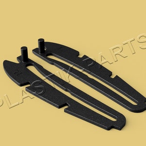 May include: Two black plastic pieces with a small, round, black knob on each end. The pieces are shaped like a long, thin, curved blade.