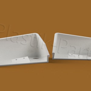 May include: Two white plastic parts with rounded edges and holes. The parts are on a brown surface.