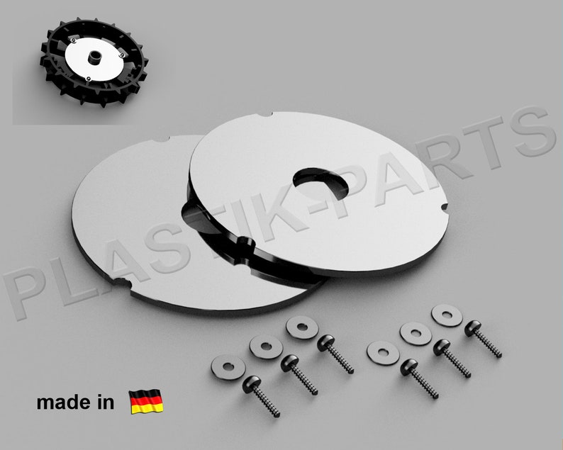 May include: Two silver-colored metal discs with a hole in the center, stacked on top of each other. There are six black screws and six black washers included. The discs have the text "PLASTIKPARTS" printed on them. The text "made in" and a German flag are also visible.