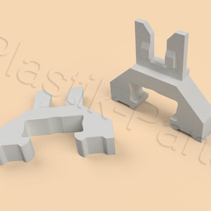 Op de afbeelding: Twee witte plastic clips, een is recht en de andere is gebogen. Beide clips hebben een U-vormige opening.